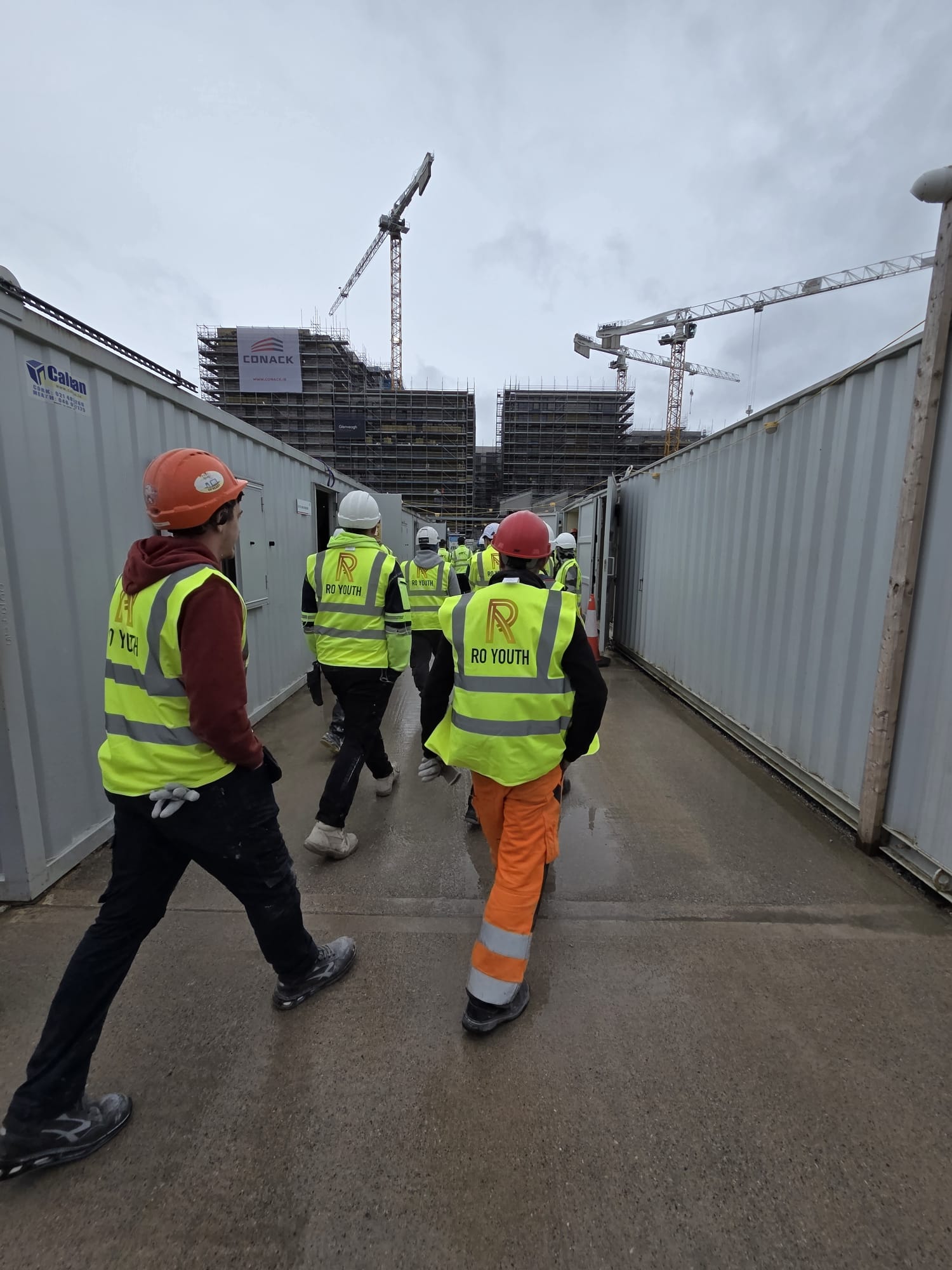 RO Youth crew in branded hi-vis vests walking out to a live site