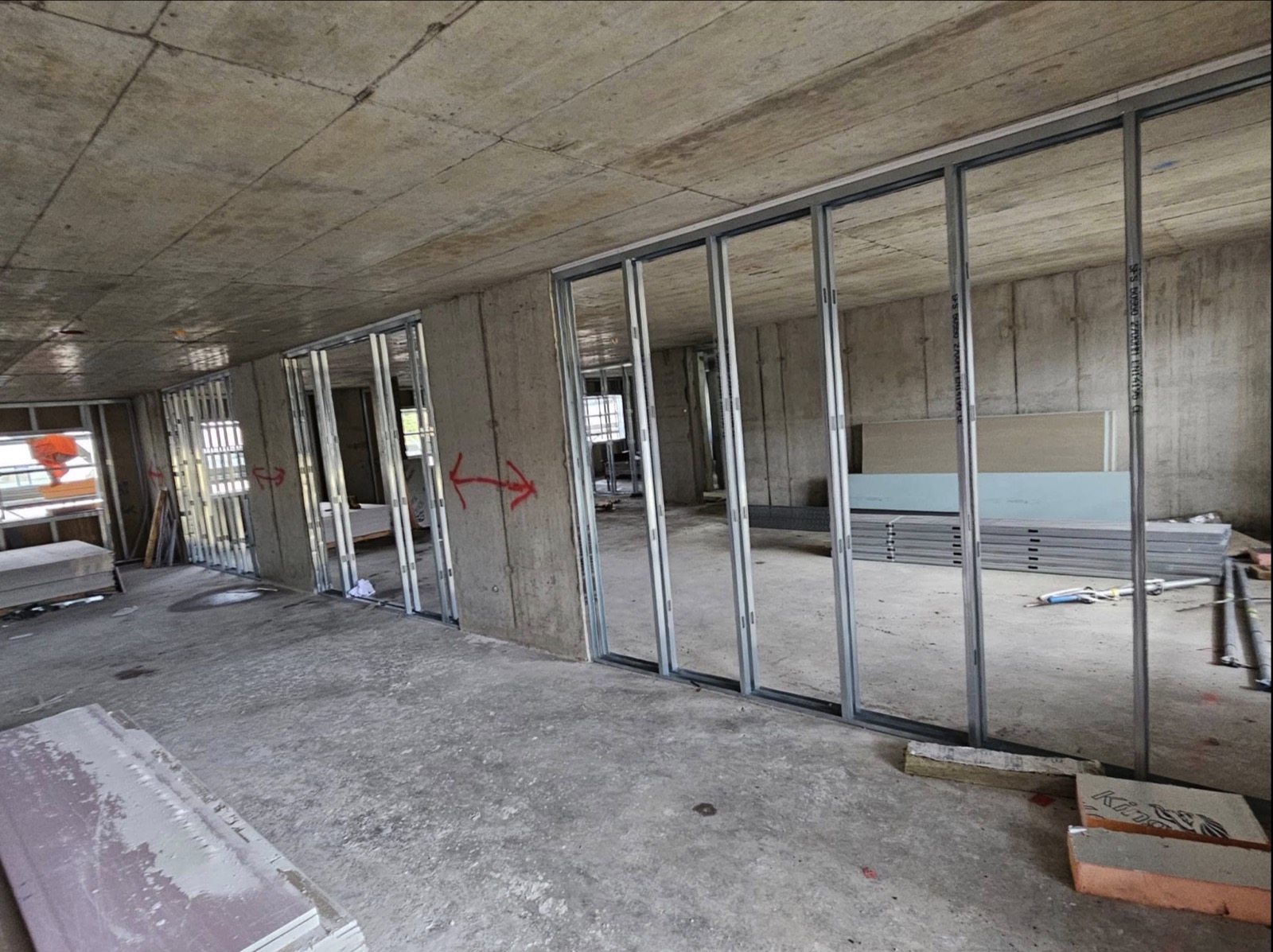 Open commercial floor with metal stud partitions being installed