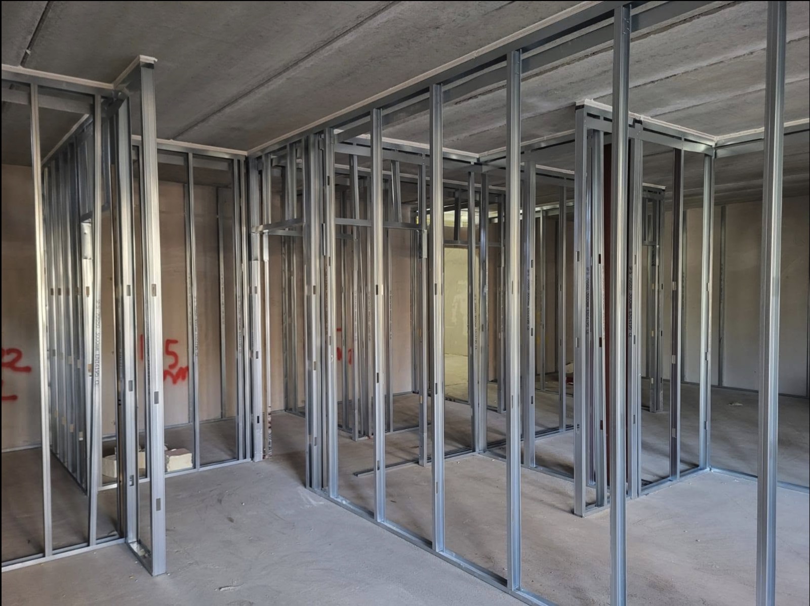 Multiple partition frames forming rooms in a commercial fitout