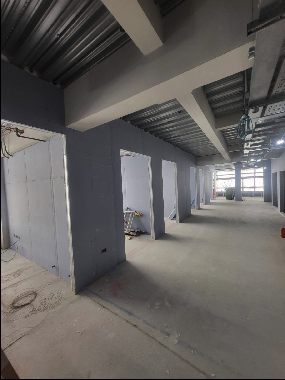 Commercial fitout corridor with plasterboard walls and ceiling works